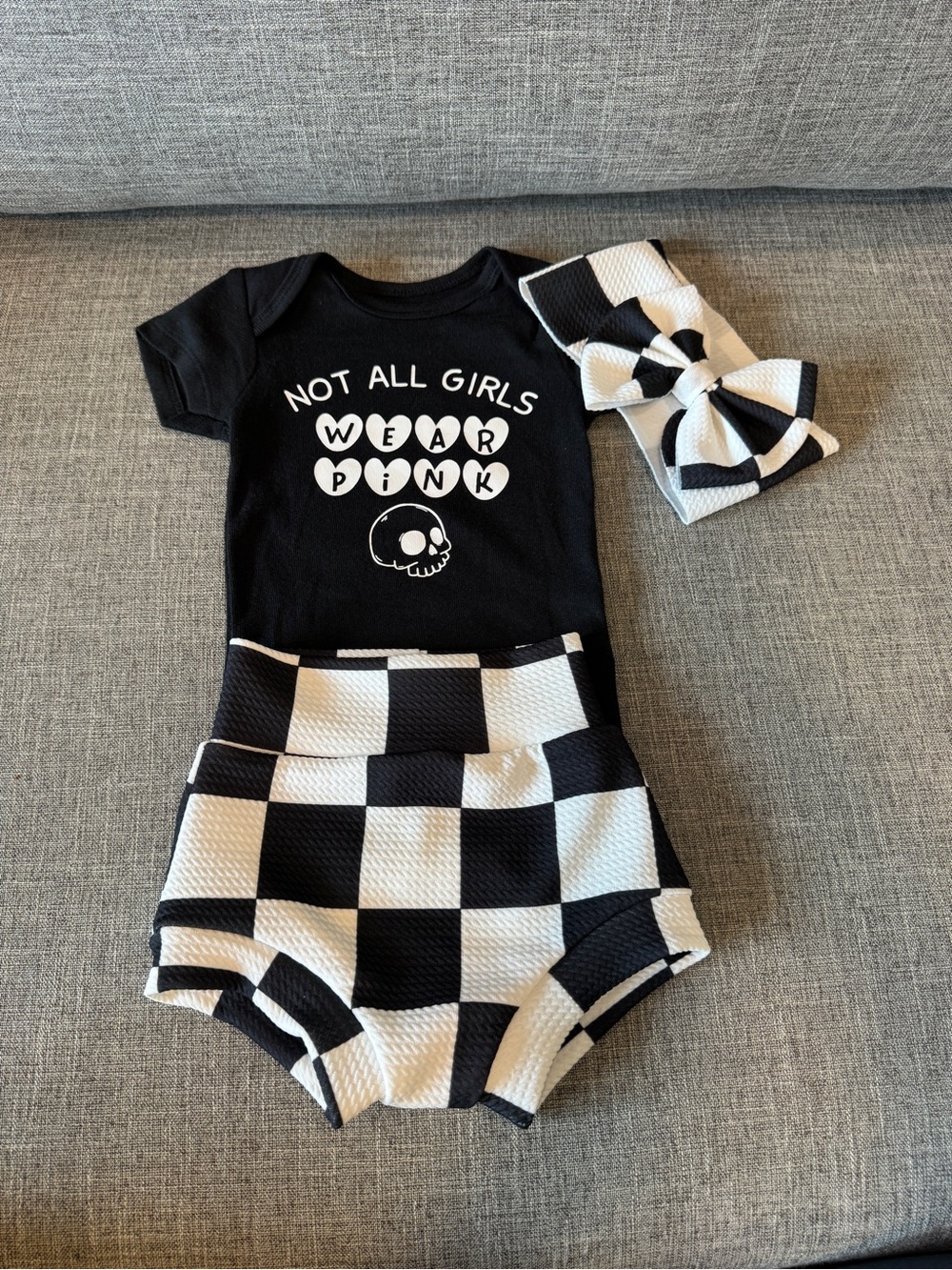 Black 'Not All Girls Wear Pink' Baby Outfit with Checker Shorts and Headband
